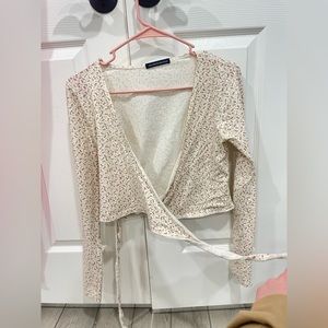 Brandy Melville long sleeve wrapped top with a floral pattern.